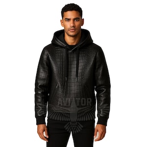 May include: Black hooded sweatshirt with a textured, grid-like pattern. The sweatshirt features a kangaroo pocket and ribbed cuffs and hem. The word "AVIATOR" is printed on the front, along with a graphic of a bird.