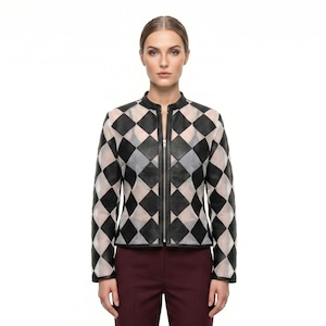 May include: A long-sleeved jacket featuring a black and white diamond checkerboard pattern. The garment has a mandarin collar, a full-length vertical silver zipper closure down the center, and a structured fit with long sleeves and a straight hemline.