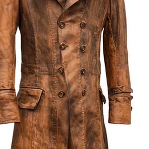 May include: A brown leather coat with a double-breasted design. The coat features multiple buttons, two front pockets, and buttoned cuffs. The leather has a distressed, weathered appearance, with variations in color.