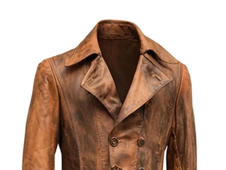 May include: A brown leather double-breasted coat with a wide collar. The coat has a distressed, vintage appearance with visible wear and tear. The coat has two rows of buttons and a classic trench coat design.
