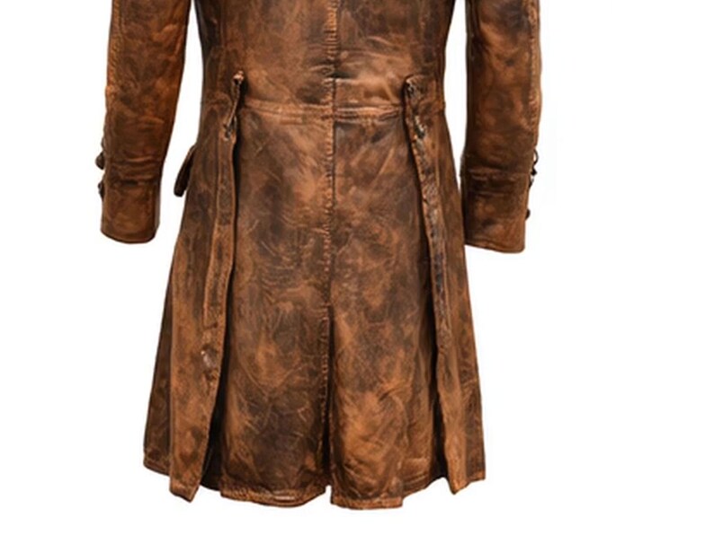 May include: A brown leather coat with a distressed finish. The coat features long sleeves, button details, and a split back design. The leather has a worn, textured appearance, suggesting a vintage or rugged style. The coat is a medium length.