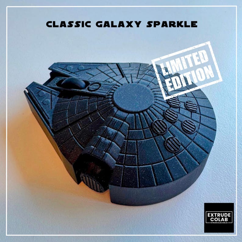 May include: A black computer mouse shaped like a spaceship with a textured finish. The text CLASSIC GALAXY SPARKLE appears at the top, and a white stamp with the text LIMITED EDITION is visible. A black square logo with EXTRUDE COLAB is at the bottom.