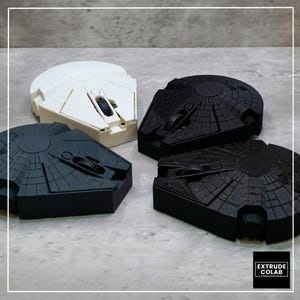 May include: Four computer mice shaped like the Millennium Falcon starship. One mouse is white, two are matte black, and one is black with a subtle glitter finish. Each device features a central scroll wheel and detailed paneling.