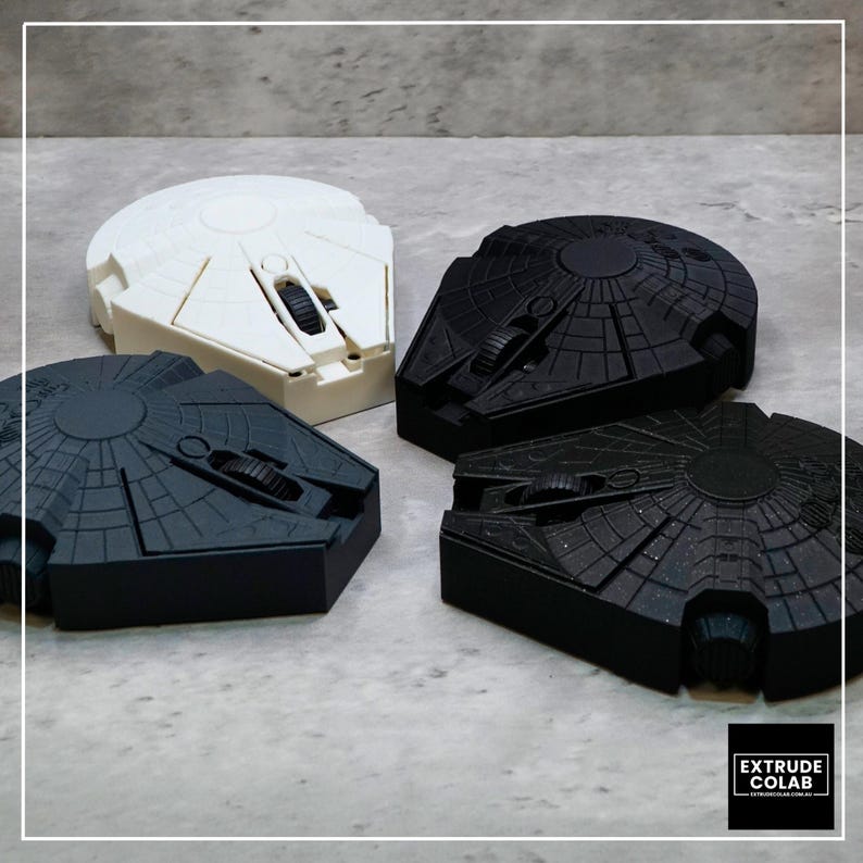 May include: Four computer mice shaped like the Millennium Falcon starship. One mouse is white, two are matte black, and one is black with a subtle glitter finish. Each device features a central scroll wheel and detailed paneling.