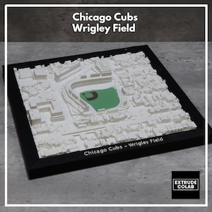 May include: A 3D model of Wrigley Field, home of the Chicago Cubs, in a black frame. The model is white with a green baseball field. The text "Chicago Cubs Wrigley Field" is at the top, and "Chicago Cubs - Wrigley Field" is at the bottom.