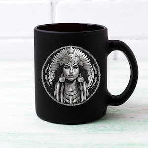 May include: Black ceramic mug with a white graphic of a Native American woman wearing a headdress and jewelry.