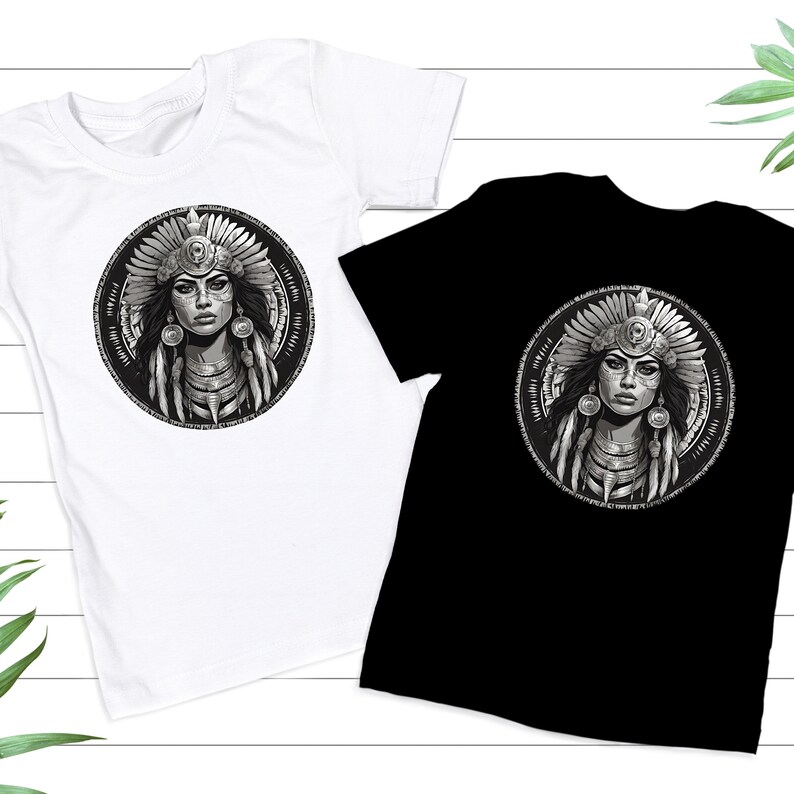May include: Two t-shirts with a black and white graphic print of a Native American woman wearing a headdress. The woman's face is painted with black and white markings. The graphic is in a circle with a geometric pattern around it.