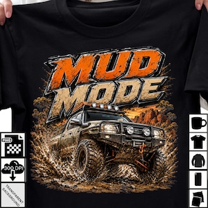 May include: A black t-shirt featuring a graphic of an off-road vehicle driving through mud. The text MUD MODE is printed in large, bold, orange and beige letters above the vehicle. The design includes splashes of mud and a desert landscape.