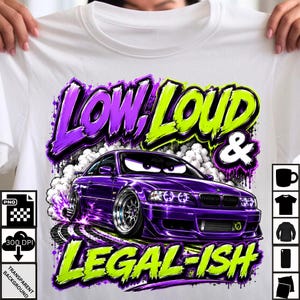 May include: A white t-shirt featuring a graphic of a purple sports car with large wheels and stylized eyes on the windshield. The text reads "LOW, LOUD & LEGAL-ISH" in purple and lime green graffiti-style lettering, surrounded by white smoke clouds.
