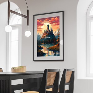 May include: A framed print of a digital illustration of Hogwarts castle, a fictional school of witchcraft and wizardry, set against a sunset sky with a full moon. The castle is perched on a hill overlooking a river and mountains. The text "HOGWARTS" is printed below the castle.