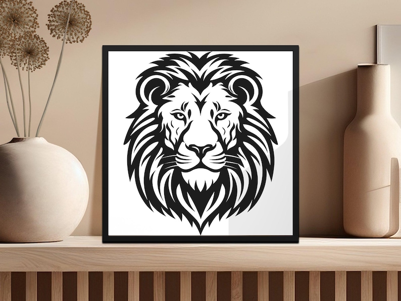 May include: Black and white illustration of a lion's head with a thick mane. The lion is looking directly at the viewer.