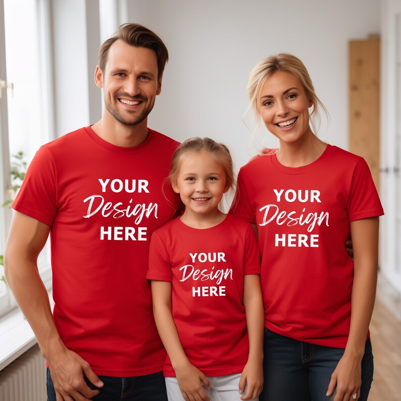 May include: A family of three wearing red t-shirts with the text "Your Design Here" printed on them. The father is wearing a red t-shirt with the text "Your Design Here" printed on it. The mother is wearing a red t-shirt with the text "Your Design Here" printed on it. The child is wearing a red t-shirt with the text "Your Design Here" printed on it.