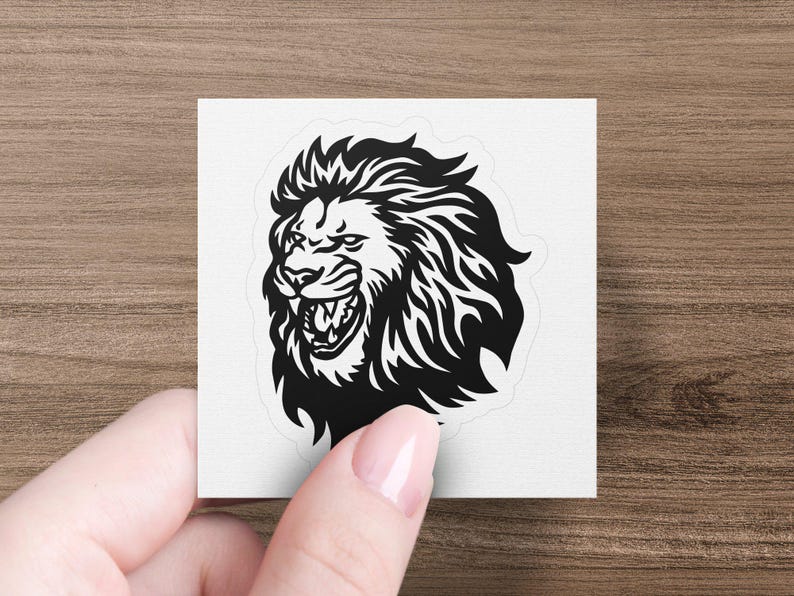 May include: Black and white illustration of a roaring lion's head with a detailed mane.