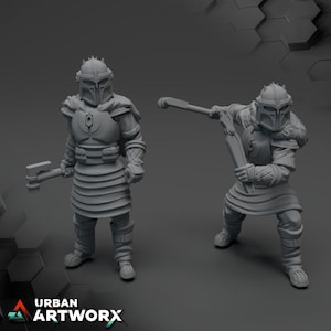 May include: Two grey unpainted miniature figurines of armoured warriors wearing helmets with crests, chest plates, and layered skirts. One figure stands holding a small axe, while the other is in a dynamic pose wielding a long-handled weapon.