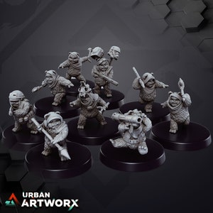 Könnte beinhalten: Ein Set aus neun grau bemalten Miniaturfiguren von Ewoks, jede mit einer anderen Waffe oder einem anderen Werkzeug, die auf schwarzen runden Sockeln stehen.