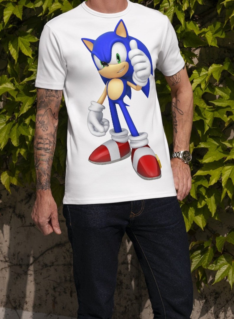 May include: White t-shirt with a blue and red cartoon character of Sonic the Hedgehog giving a thumbs up.