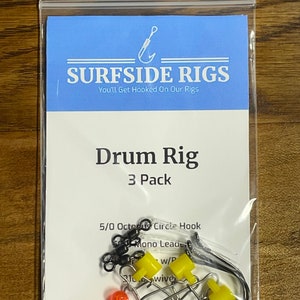 May include: A package of three drum fishing rigs. The package includes 5/0 Octopus Circle Hooks, mono leader, and beads. The package is labeled "Drum Rig 3 Pack".
