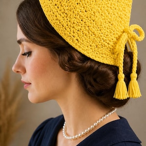 May include: A bright yellow crochet headscarf with tassel ties. The head covering is made of a textured yarn and is tied at the nape of the neck. The headscarf is a vibrant accessory, perfect for adding a pop of color to any outfit.