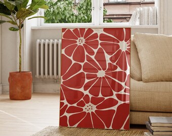 May include: A framed print of a red floral design with white outlines. The print is hanging on a white wall in a living room setting.