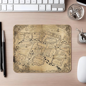 May include: A rectangular mouse pad featuring a vintage-style parchment map design with intricate black line drawings of a castle floor plan, including labels like Great Hall, Potions, and Transfiguration, surrounded by ornate decorative borders.