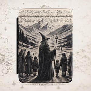 May include: A rectangular e-reader case featuring a black and white illustration of a wizard holding a staff, accompanied by a group of figures standing before a mountain range. The top section displays Elvish script, and the design has a textured finish.