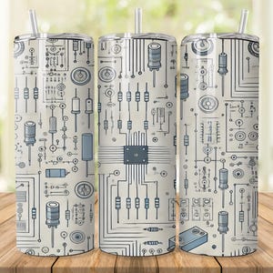 Puede incluir: Tres vasos de acero inoxidable con un diseño de placa de circuito. El diseño presenta una red de líneas, círculos y formas rectangulares en tonos grises y azules sobre un fondo crema. Cada vaso tiene una pajita plateada.