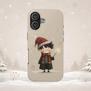 May include: A beige smartphone case featuring a cartoon illustration of a young person with dark hair and round glasses, wearing a red winter hat and scarf, holding a glowing wand against a snowy landscape with pine trees and falling snowflakes.