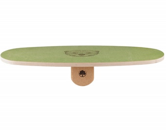 May include: A green balance board with a light brown wooden base and a cork support. The board has an oval shape with a light green surface and a printed otter design. The cork support has a tree logo.