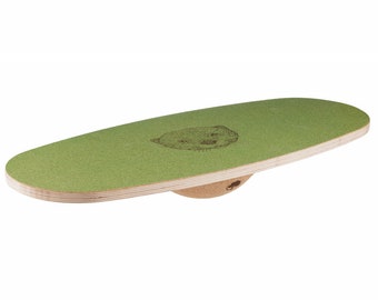May include: A green balance board with a cork base and an otter graphic. The board is made of wood and has a textured surface.