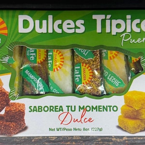 May include: A rectangular box of La Fe Dulces Típicos Puerto Rico containing assorted individually wrapped sweets. The green packaging features images of brown, yellow, and red candies, with the text "Saborea tu momento dulce" and "Net WT 8oz (227g)."