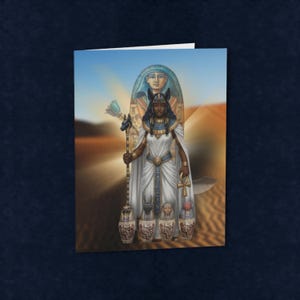 May include: A greeting card featuring a digital illustration of a dark-skinned figure dressed in white Egyptian-style robes, holding a staff topped with a jackal head and an ankh. Four small canopic jars sit at the base against a desert background.