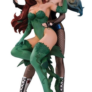 May include: A green and black Poison Ivy statue holding a red rose, and a Harley Quinn statue wearing black and white fishnet stockings and a blue and black costume.