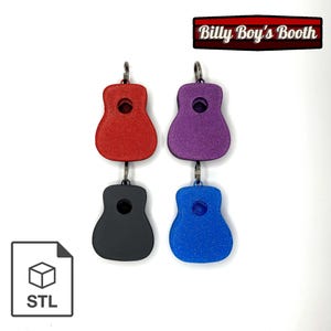 May include: Four colorful guitar-shaped keychains in red, purple, black, and blue. Each keychain has a circular hole and a metal ring for attachment. The keychains are arranged in a square formation. The text "Billy Boy's Booth" is at the top.