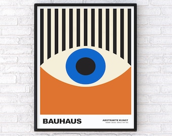 May include: A framed Bauhaus art print featuring a stylized eye design. The artwork includes a blue iris, a black pupil, and an orange lower section. The top portion has black and white vertical stripes, with the word "BAUHAUS" at the bottom.