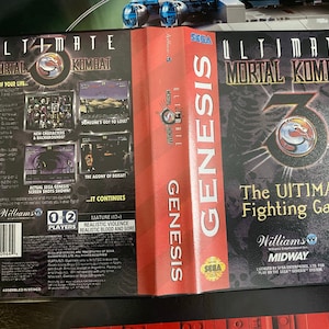 May include: A Sega Genesis game cartridge for Ultimate Mortal Kombat 3. The front of the cartridge features a black and red design with the game title and a logo of a dragon. The back of the cartridge features a description of the game, including the game's rating, which is Mature (17+).