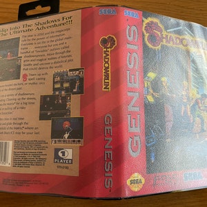 May include: A SEGA Genesis video game box for Shadowrun. The box is red and black with the game title in large, bold letters. The back of the box features screenshots and text describing the game's cyberpunk setting and gameplay. The game is rated MA-13.