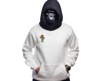 May include: A white hooded sweatshirt with a black hood and a small colorful graphic on the front. The hood is pulled up and a gorilla mask is covering the face.