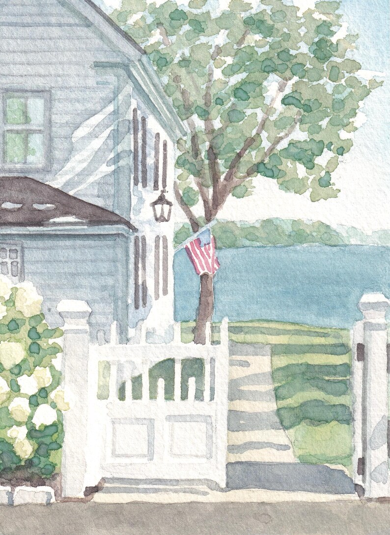 May include: Watercolor painting of a coastal scene featuring a white picket fence, a house with gray siding, and a tree with green leaves. An American flag is attached to the tree. The scene is painted in soft watercolor hues.