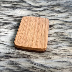 May include: A rustic wooden sign with the text "Welcome to our home" in white lettering. The sign features a distressed finish and a simple, inviting design, perfect for a front porch or entryway.