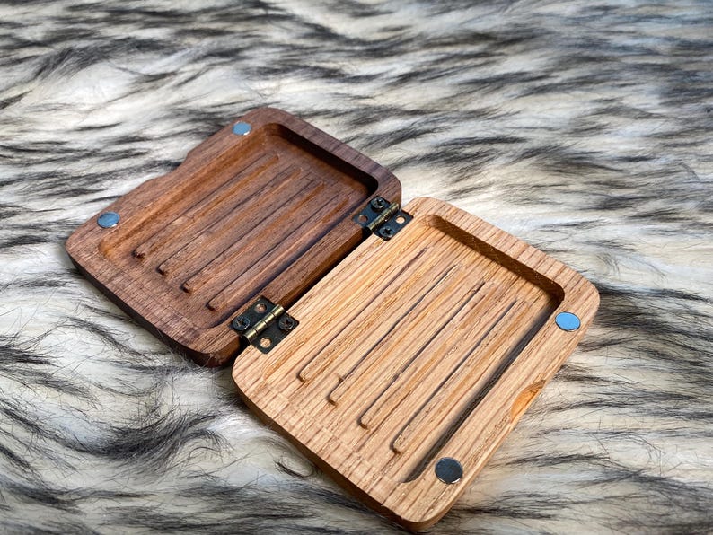 May include: A white ceramic mug with a black handle and the text "But First, Coffee" in a black, bold font. The mug is on a white surface. The mug is approximately 4 inches tall.