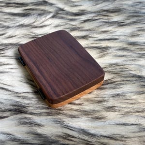 May include: A set of three ceramic mugs with a speckled, matte finish. The mugs are in shades of cream, light gray, and dark gray. Each mug has a simple, minimalist design, perfect for coffee or tea.