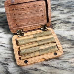 May include: A rustic wooden sign with the text "Welcome to our home" in white lettering. The sign features a distressed finish and a simple, inviting design, perfect for a front porch or entryway.