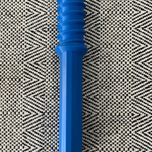 May include: A vibrant blue, cylindrical object with a ridged top and a faceted, elongated body. The object is a solid color and appears to be made of plastic or a similar material. The design is symmetrical and modern, with a smooth finish.