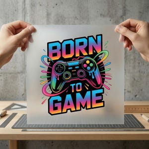 May include: A colorful graphic featuring a video game controller with the text "BORN TO GAME". The controller is black with rainbow accents, and the text is in a vibrant gradient of blue, orange, and pink.