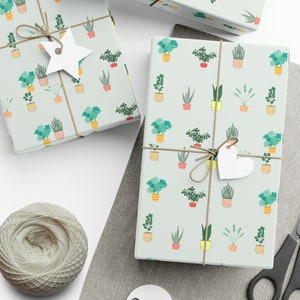 May include: A set of three gift wrap sheets with a repeating pattern of potted plants in various colors and styles. The sheets are tied with twine and have paper tags attached.
