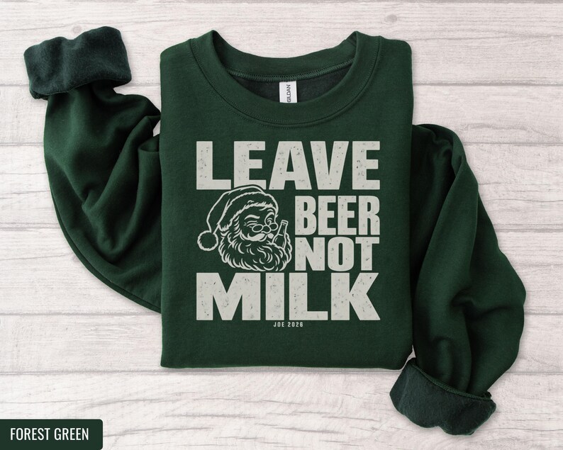 Dark green crewneck sweatshirt featuring a graphic of Santa holding a beer with text that reads Leave Beer Not Milk.