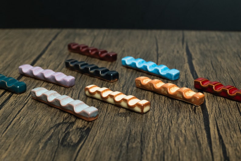 Colorfull paint brush holders on wooden table.