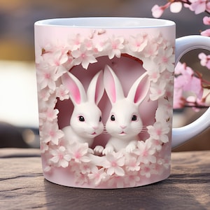 May include: White ceramic mug with a pink background featuring two white rabbits peeking out from a circle of pink cherry blossoms.