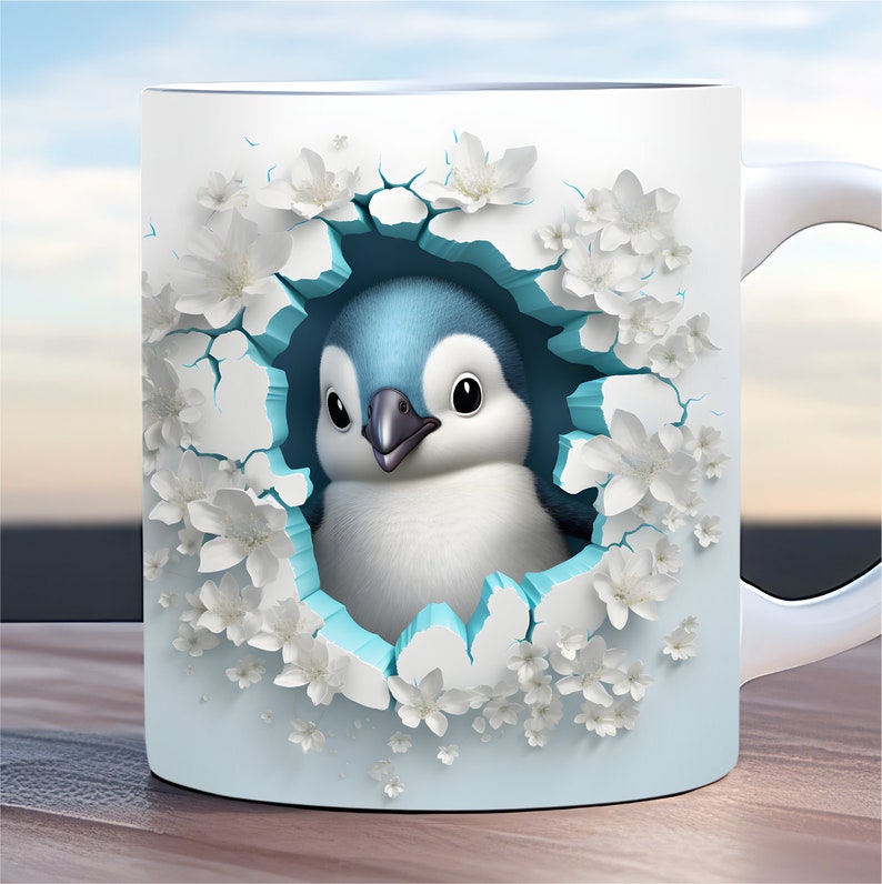 May include: A white ceramic mug featuring a blue and white penguin peeking out of a hole surrounded by white flowers. The mug has a light blue background.