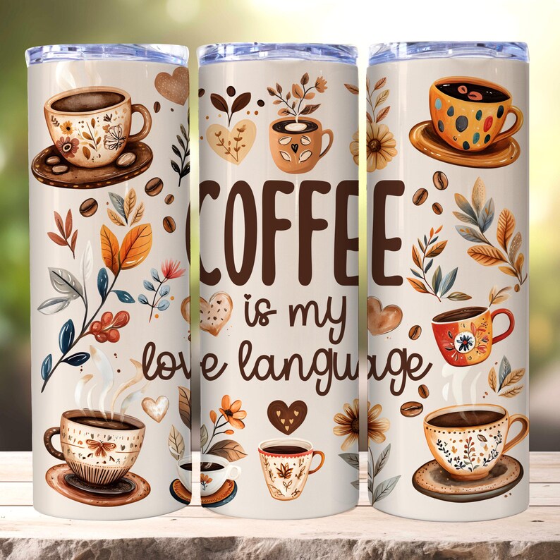 May include: A white tumbler with a brown and cream floral design. The tumbler has the text "COFFEE is my love language" on it.